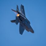 A powerful jet fighter performing a maneuver at the Bengaluru air show, showcasing speed and precision.