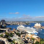 a cruise ship in the water near a city