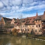 a row of buildings next to a body of water