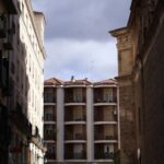 A narrow city street with a building in the background