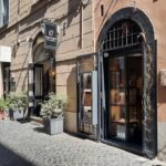a narrow street with potted plants on the side of it
