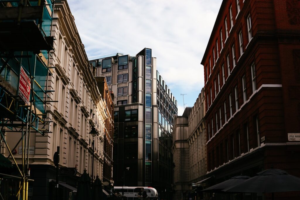 cars parked beside brown concrete building during daytime