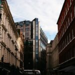 cars parked beside brown concrete building during daytime