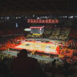 A view of a basketball court from the upper level of a stadium