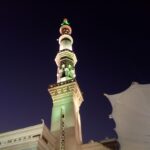 a tall clock tower lit up at night