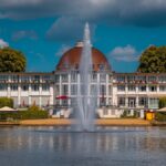 A large building with a fountain in front of it