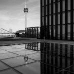 A skyscraper and its reflection after the rain.