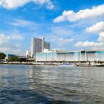a body of water with buildings in the background