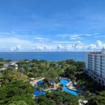 an aerial view of a resort with a pool in the foreground