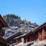 a row of buildings with a mountain in the background