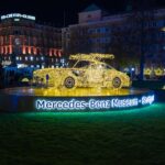 A lit up car in the middle of a field