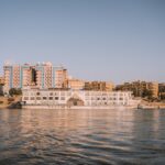 a body of water with buildings in the background