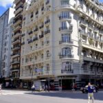 a tall white building sitting on the side of a street