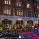 A large building with cars parked in front of it