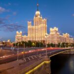 A city skyline with a bridge over a river