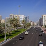 a highway with cars on it and buildings in the background