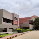 a building that has a lot of trees in front of it