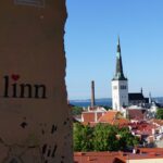 A view of a city with a steeple in the background