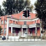 a red building with a traffic light in front of it