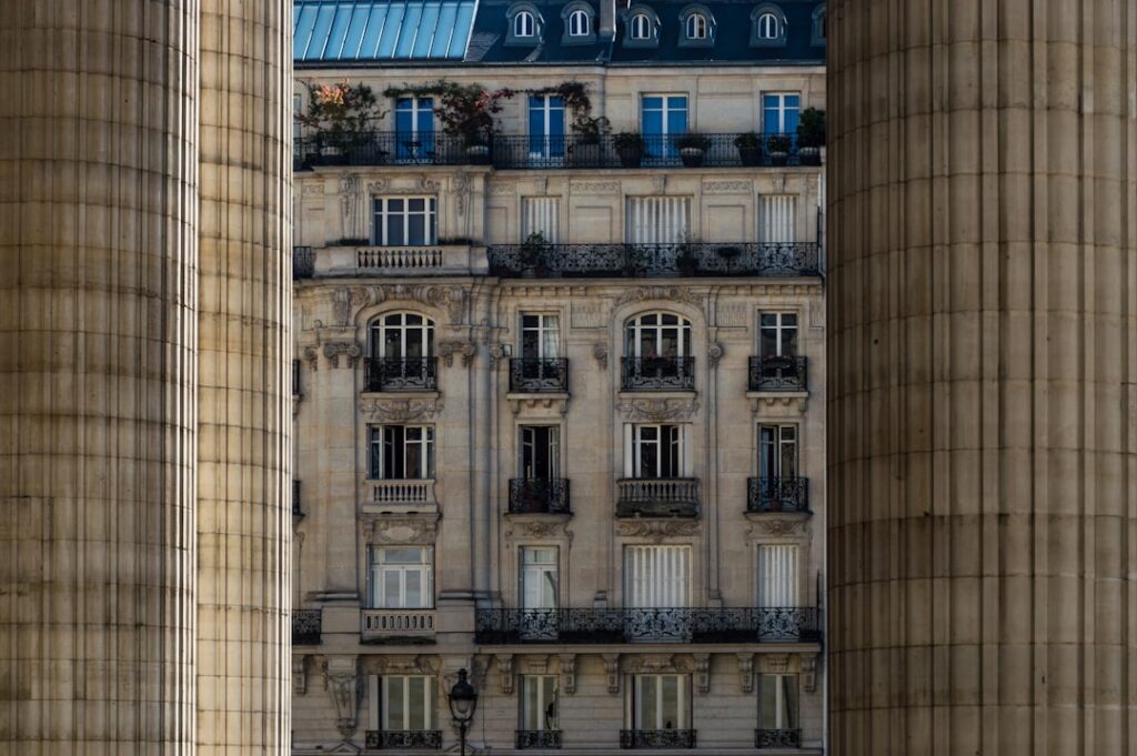 Buildings in paris framed by columns.