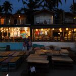 A group of tables sitting on top of a sandy beach