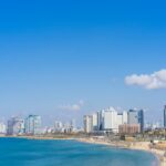 city skyline across blue sea under blue sky during daytime