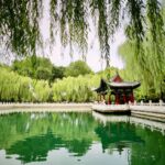 a pond with a pavilion in the middle of it