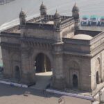 An aerial view of a large building near a body of water