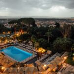 swimming pool surrounded by trees during night time