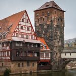 a building with a tower next to a bridge
