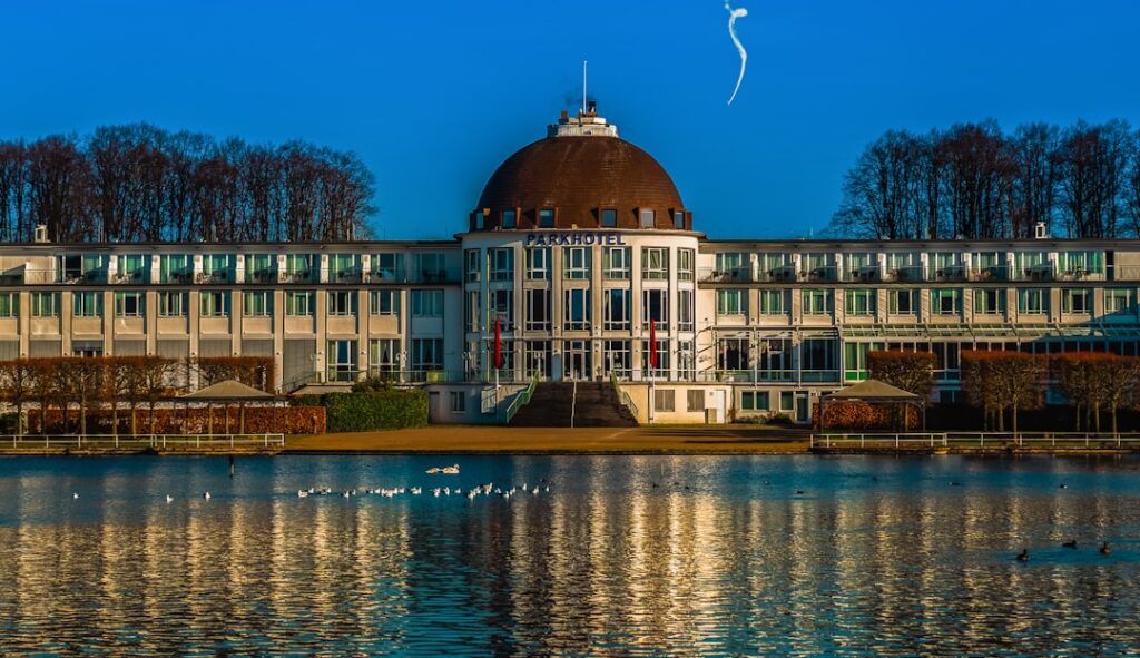 a large building with a dome on top next to a body of water