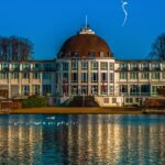 a large building with a dome on top next to a body of water